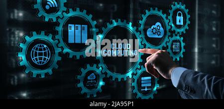 Cloud computing concept. Businessman is pressing on the virtual screen inscription Cloud computing Stock Photo