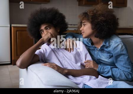 Pretty young teen African girlfriend saying sorry after row Stock Photo