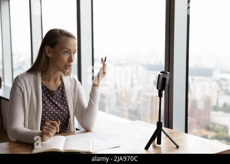 Business teacher giving training, recording lesson on smartphone Stock Photo