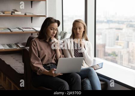 Serious engaged business coworkers with digital gadgets meeting, Stock Photo