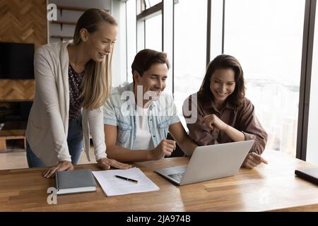 Happy business team watching online training or virtual presentation Stock Photo