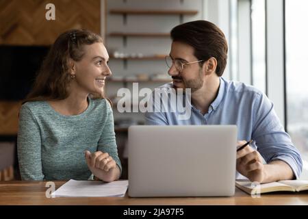 Business mentor and happy intern discussing training task at workplace Stock Photo