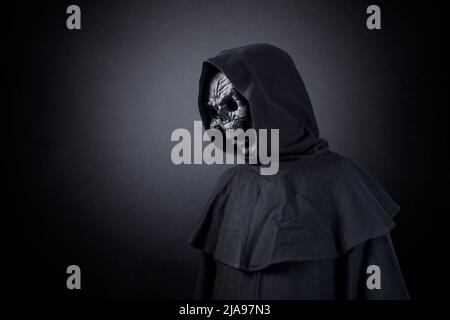 Grim reaper over dark misty background Stock Photo