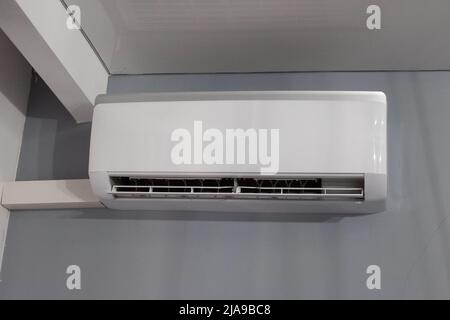 Air conditioner on gray wall room interior Stock Photo - Alamy