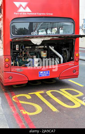 Broken down National Express red double decker London bus parked at Bus Stop with diesel engine cover open waiting breakdown assistance to arrive UK Stock Photo