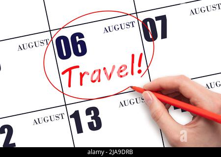 6th day of August. Hand drawing a red circle and writing the text TRAVEL on the calendar date 6 August. Travel planning. Summer month. Day of the year Stock Photo
