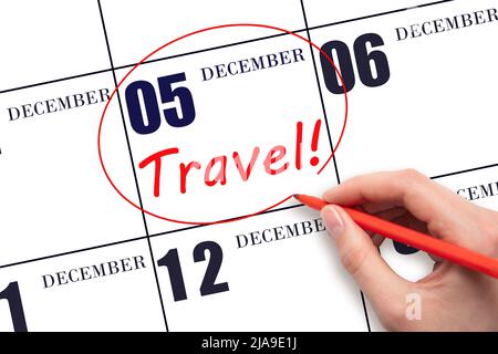 5th day of December. Hand drawing a red circle and writing the text TRAVEL on the calendar date 5 December. Travel planning. Winter month. Day of the Stock Photo