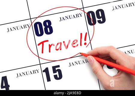 8th day of January. Hand drawing a red circle and writing the text TRAVEL on the calendar date 8 January. Travel planning. Winter month. Day of the ye Stock Photo