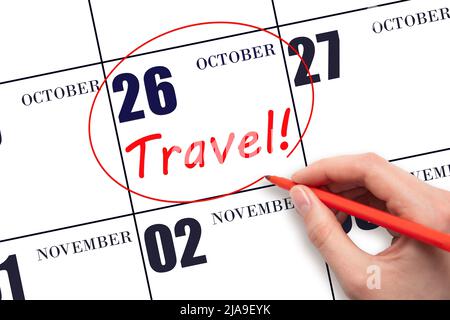 26th day of October. Hand drawing a red circle and writing the text TRAVEL on the calendar date 26 October. Travel planning. Autumn month. Day of the Stock Photo
