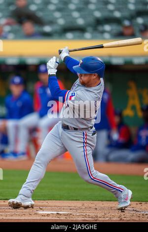 Oakland, USA. 26th May, 2022. Texas Rangers right fielder Kole Calhoun (56)  swings at a pitch during the second inning against the Oakland Athletics in  Oakland, CA Thursday May 26, 2022. (Image