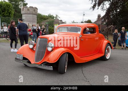 Lamorlaye, France - July 05 2020: Orange customised 1934 Ford Model 40 coupe 3 windows with a V8 engine. Stock Photo