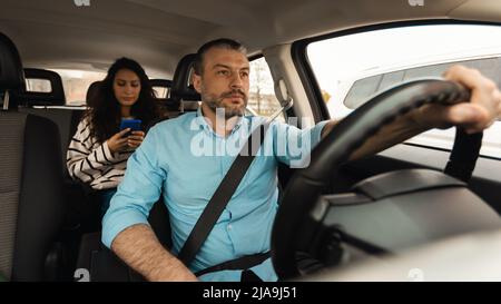 Portrait of male driver riding car with passenger Stock Photo