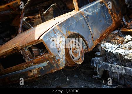 A lot of rusty burnt cars in Irpen, after being shot by the Russian military. Stock Photo