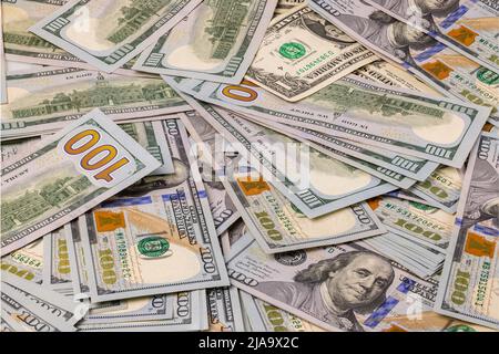 Close up view of scattered 100 dollar banknotes on background. Economy cash concept. Sweden. Stock Photo