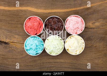 Ice-cream of various taste in paper cups. Stock Photo