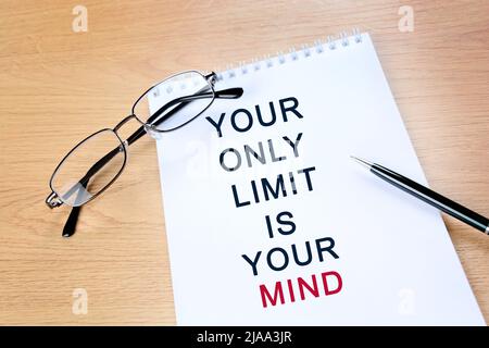 Your only limit it your mind text on notepad page. Motivational quote Stock Photo