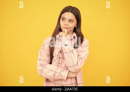 thoughtful look. tween child wear plaid shirt. chequered flannel jacket. beauty and fashion. Stock Photo