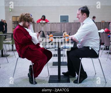 Cosplayers taking a break during MCM Comic Con at the ExCel London in east London. Picture date: Sunday May 29, 2022. Stock Photo