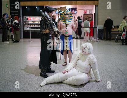 Cosplayers taking a break during MCM Comic Con at the ExCel London in east London. Picture date: Sunday May 29, 2022. Stock Photo