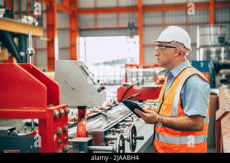 senior engineer professional worker caucasian worker working in heavy industry factory Stock Photo