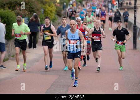 Portobello promenade, Edinburgh, Scotland, UK 29th May 2022. Edinburgh Marathon Festival runners set off at 10am. Pictured  runners exiting the east end of the promenade. Stock Photo