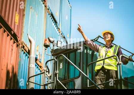 Asian senior elder worker working control load lifting cargo in transport shipping industry Stock Photo