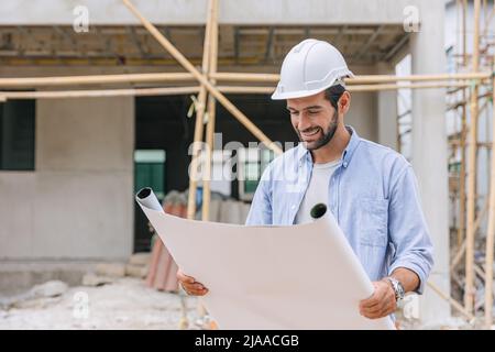 Engineer builder architect enjoy working looking floor plan in home construction site happy smile. Stock Photo