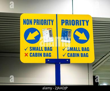 Ryan Air signs of Luggage testers measuring frames, non-priority or priority at International Airport, OTP, Otopeni, Bucharest, Romania Stock Photo