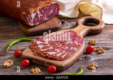 Turkish pastrami. Bacon made from ribeye meat. Beef pastrami sliced Pastirma or Turkish pastrami. Close-up. Stock Photo