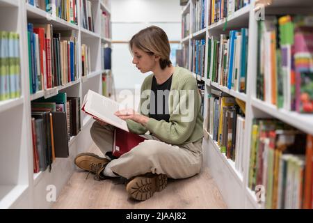 Focused attractive woman chief editor at major publishing house working on best-seller famous author Stock Photo