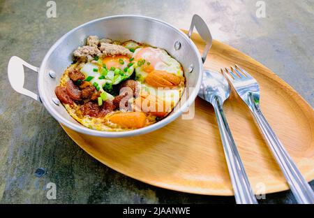 fried egg with tomato bacon in pan breakfast morning business food still life Stock Photo