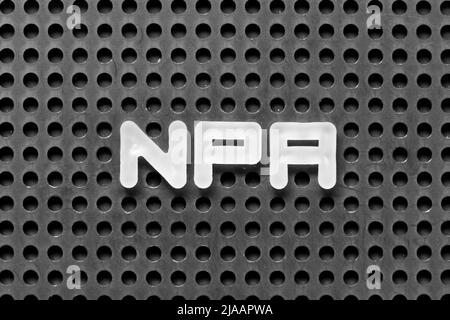 White alphabet letter in word NPA (Abbreviation of Non performing assets or Nasopharyngeal airway) on black pegboard background Stock Photo