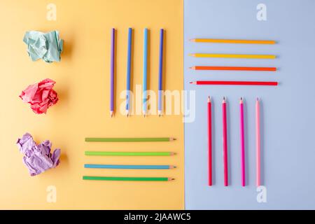 a few colored pencils and colored crumpled paper on a yellow-blue background Develop creativity Stock Photo