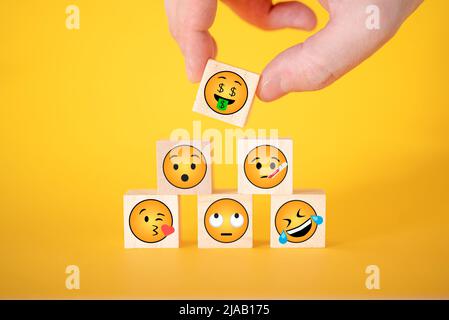 TERNOPOL, UKRAINE - May 29, 2022: Emoji yellow face dice set. An Emoji is an icon or emoticon inserted into text and used in emails and on web pages. Stock Photo