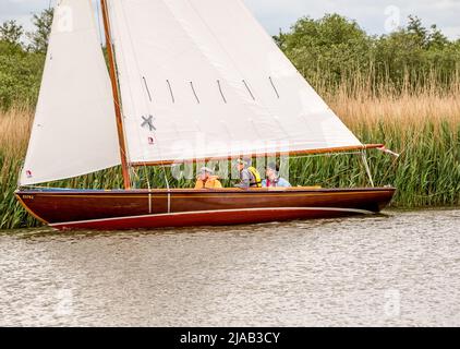 Horning, Norfolk, UK – May 28 2022. Traditional wooden sailing boat competing in the 2022 Three Rivers race, an annual boat race on the Norfolk Broads Stock Photo