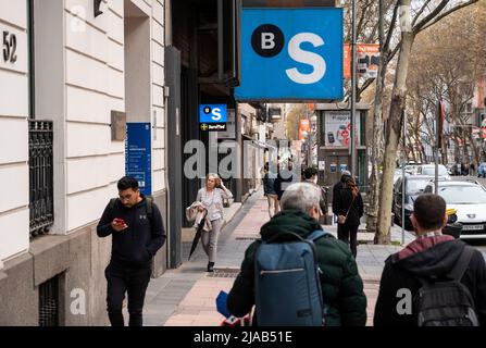 Pedestrians walk past the Spanish multinational financial services Sabadell bank in Spain. Stock Photo