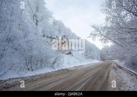 Road in Sabaduri forest with covered snow. Winter time. Landscape Stock Photo