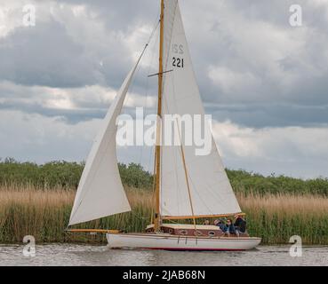 Horning, Norfolk, UK – May 28 2022. Traditional wooden river cruiser class sailing boat on the River Bure leg of the 2022 Three Rivers Race, an annual Stock Photo