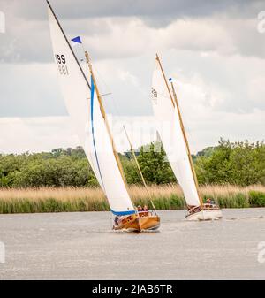 Horning, Norfolk, UK – May 28 2022. Traditional wooden river cruiser class sailing boat on the River Bure leg of the 2022 Three Rivers Race, an annual Stock Photo