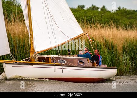 Horning, Norfolk, UK – May 28 2022. Traditional wooden river cruiser class sailing boat on the River Bure leg of the 2022 Three Rivers Race, an annual Stock Photo