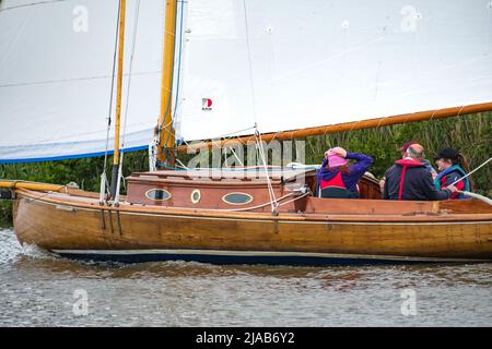 Horning, Norfolk, UK – May 28 2022. Morning Calm, a traditional river cruiser sailing on the River Bure leg of the 2022 Three Rivers Race Stock Photo