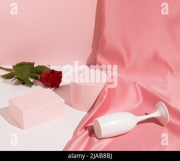 Pastel pink composition with satin curtain and palm leaf shadow ...