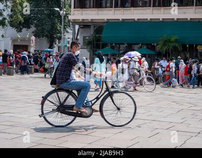 Jakarta, Indonesia - May 15, 2022: Crowds of people playing bicycles around Fatahillah Museum. Old Town, Jakarta, Indonesia. Stock Photo