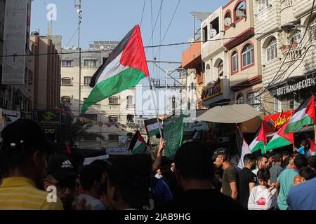 Palestinians wave Palestinian flags during a protest over tensions in Jerusalem's Al-Aqsa Mosque, in Jabalia refugee camp, northern Gaza, on Sunday, May 29, 2022. The hours before the the Israeli 'flags march' to mark Jerusalem Day, which commemorates the unification of the city after Israel annexed east Damascus Gate in 1967. Jerusalem is bracing for a controversial 'flag march' by Israelis that has sparked warnings of a new escalation from Palestinian factions. Photo by Ramez Habboub/ABACAPRESS.COM Stock Photo