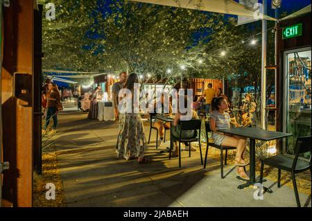 Party lights on trees with people celebrating summer festival in Tucson, Arizona.  Stock Photo