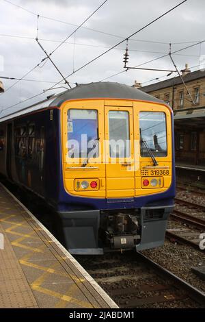 Northern trains class 319/3 4 car dual voltage electric multiple-unit, number 319368, stands at platform 1 in Preston station on 27th May 2022. Stock Photo