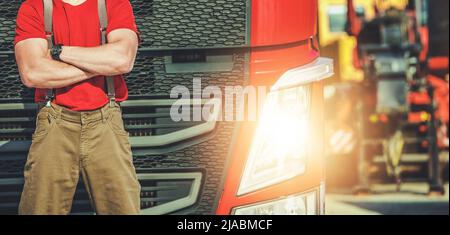 Euro Heavy Duty Transportation Industry. European Semi Truck Caucasian Driver in Front of His Modern Semi Tractor Lower Body Close Up. Stock Photo