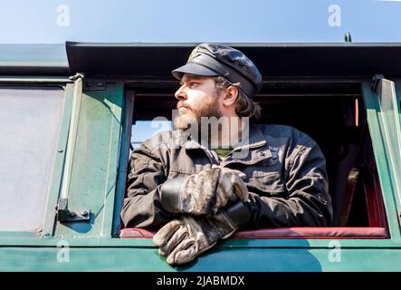 Olomouc March 3rd 2022 Czech Rep. Olomouc train depot. Train driver looking out a steam locomotive window. Stock Photo