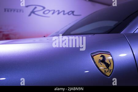 Modena, Italy - July 14, 2021: Prancing horse Yellow Logo on the Ferrari Roma type F169 model Gray front wing high-performance Italian sports car in M Stock Photo
