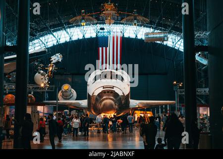 The Space Shuttle Discovery sits in front of the American flag, in the Steven F. Udvar-Hazy Center in Chantilly, VA Stock Photo